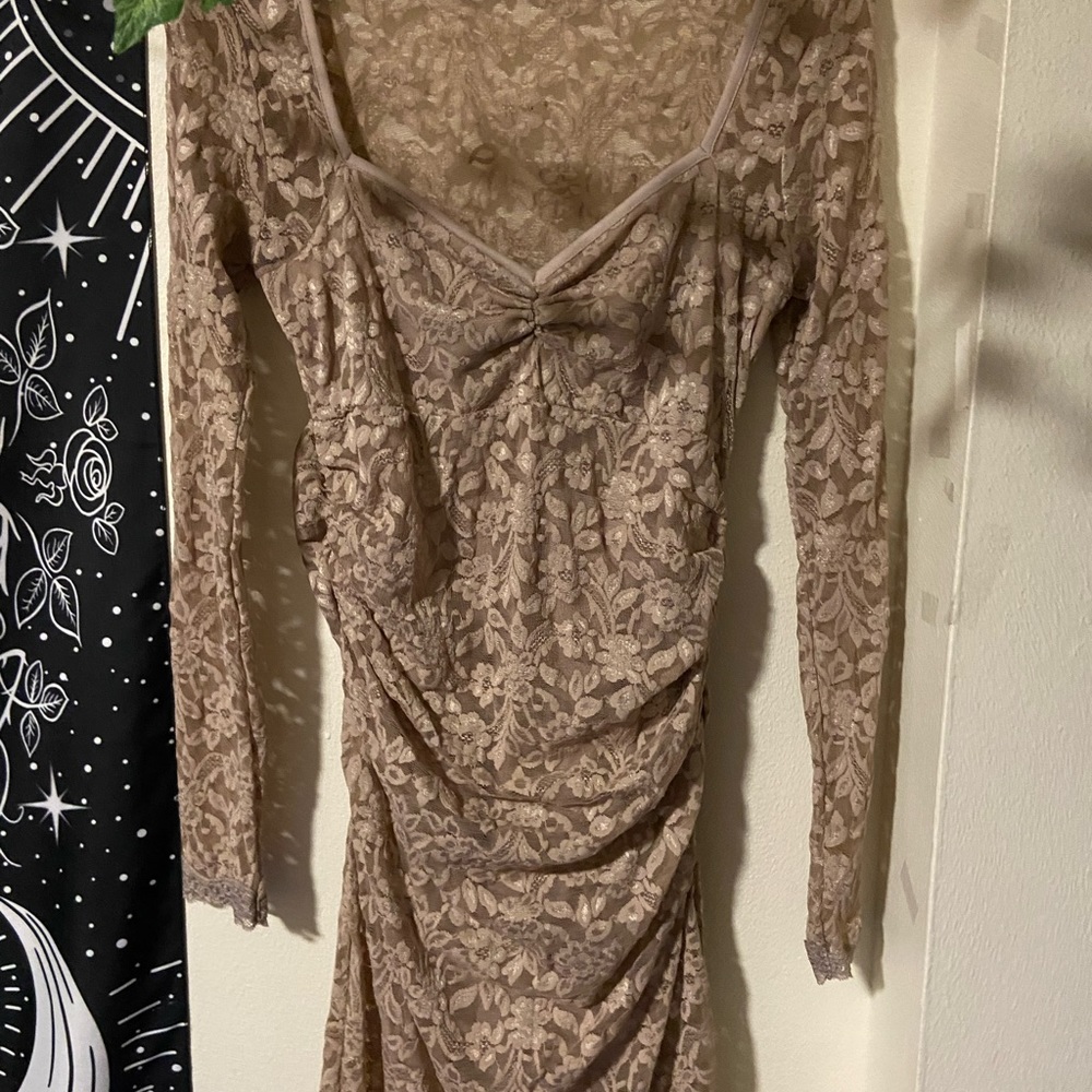 moda international brand dress is a tan nude color size medium